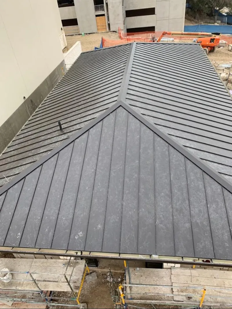 Commercial metal roof construction with crane equipment in Shorewood