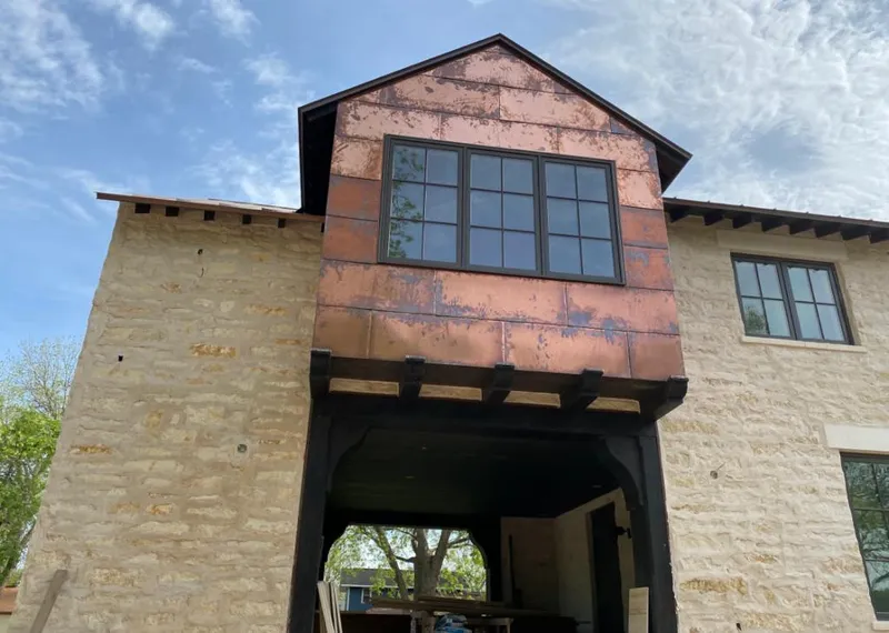 Copper metal panel facade on a stone building for Metal Roof Coating in Shorewood